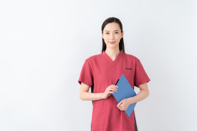 スクラブを着てファイルを持つ女性医師